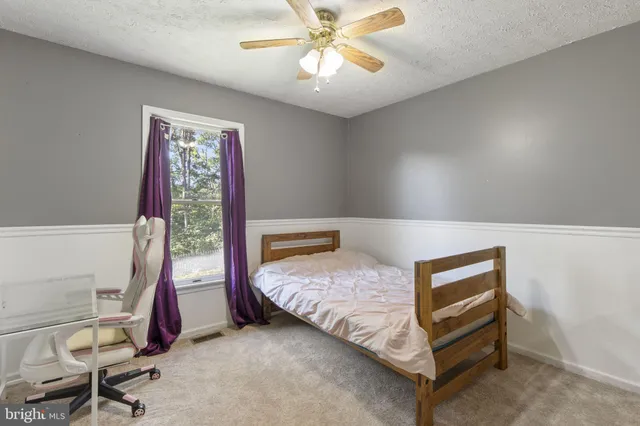 a bedroom with bed and a window