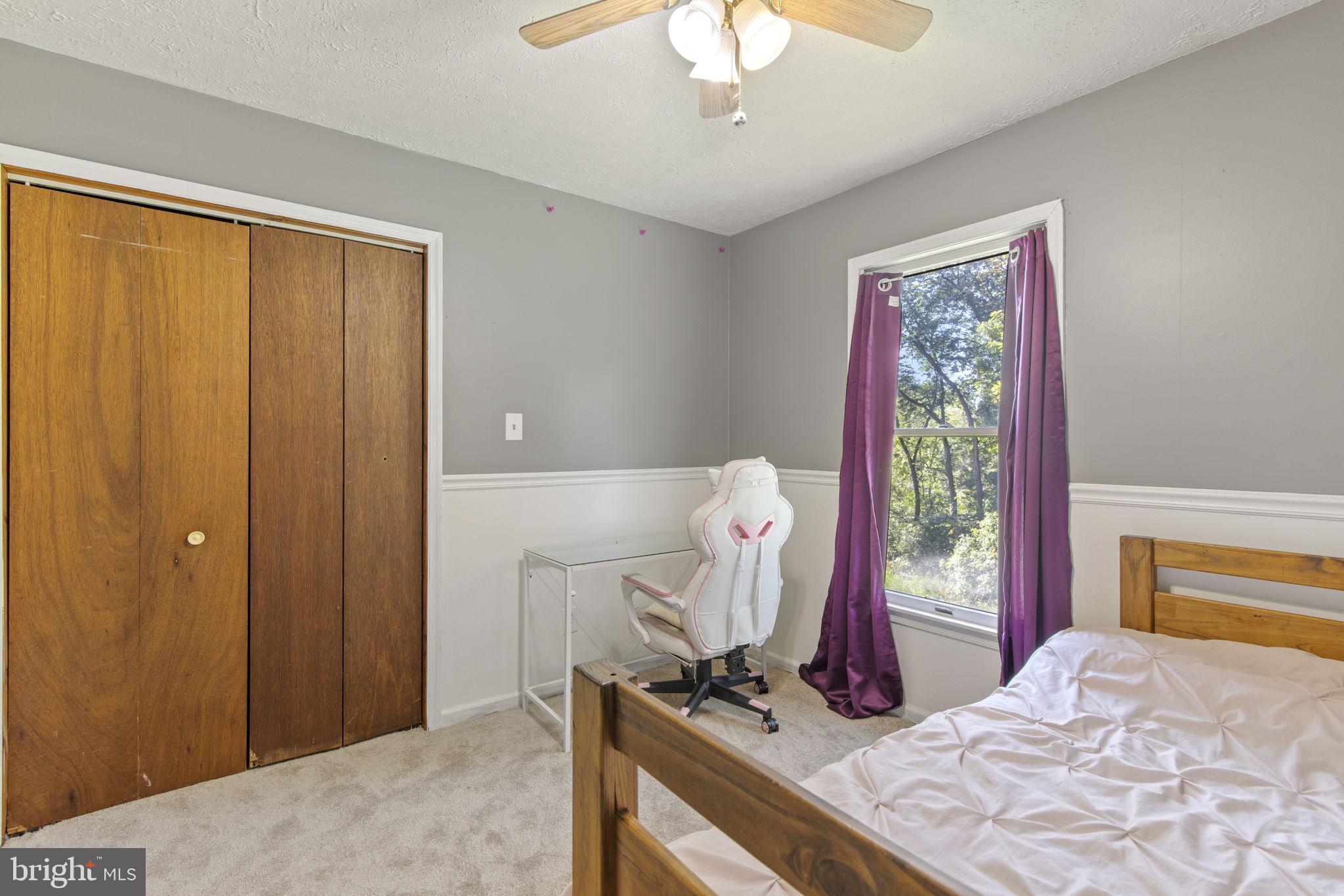 62 Porters Bridge Road Colora, MD 21917 - Photo 15 of 29 a bedroom with a bed and a chandelier