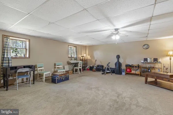 a view of a livingroom with furniture and a ceiling fan