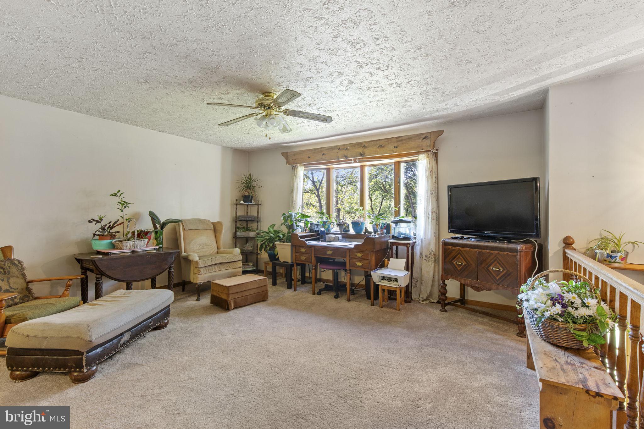 62 Porters Bridge Road Colora, MD 21917 - Photo 2 of 29 a living room with furniture and a flat screen tv