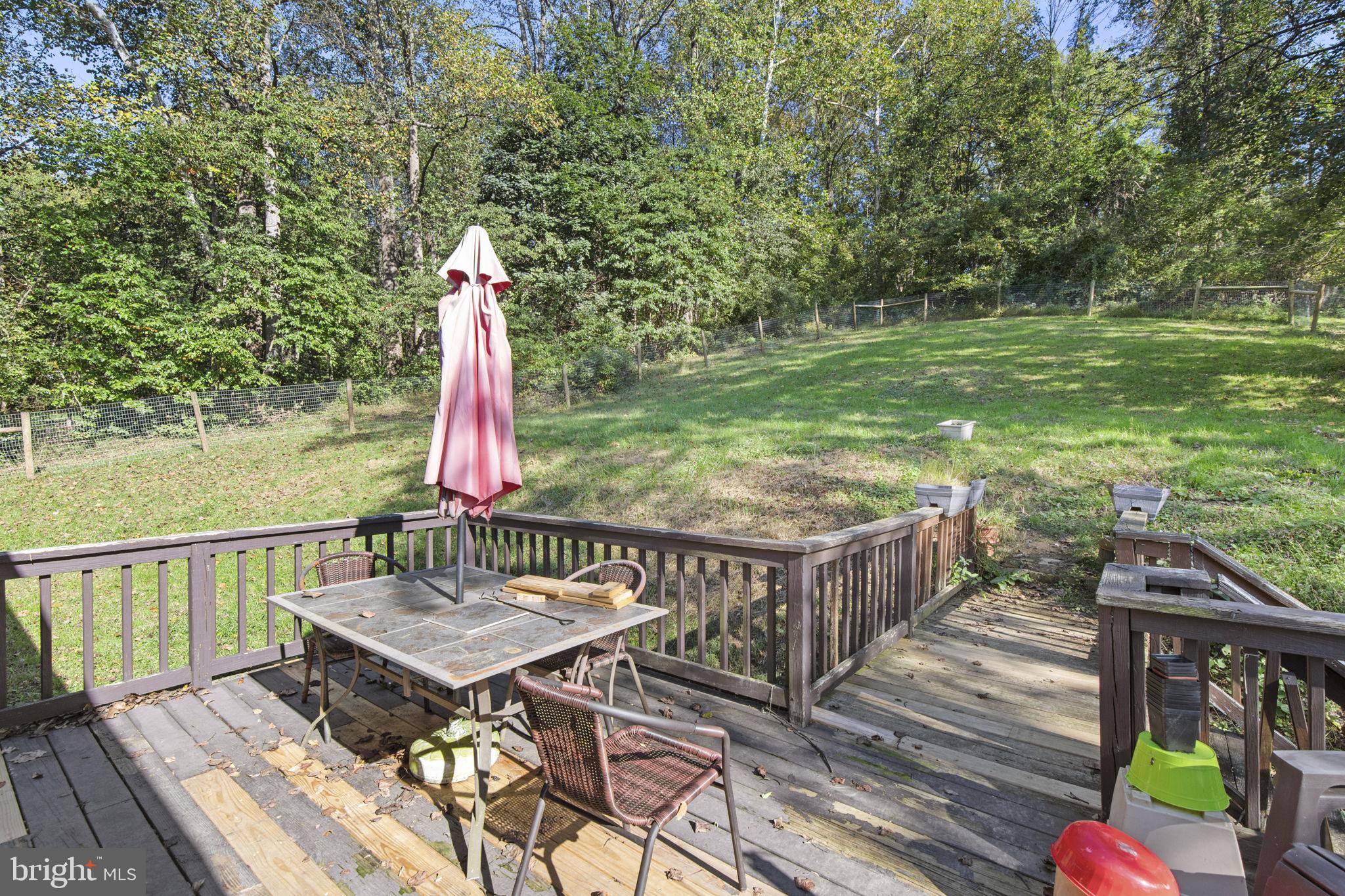 62 Porters Bridge Road Colora, MD 21917 - Photo 23 of 29 a view of a deck with a table and chairs with wooden floor and fence