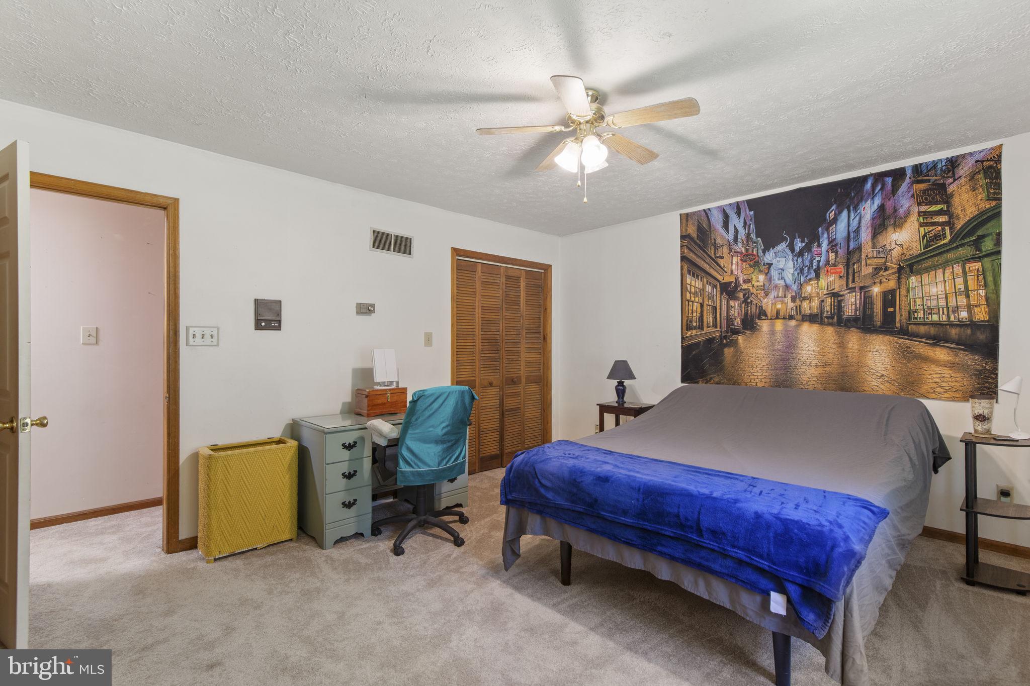 62 Porters Bridge Road Colora, MD 21917 - Photo 10 of 29 a bed room with a bed and a chandelier