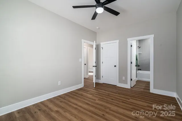 a view of a room with wooden floor and white walls