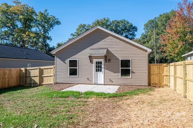 a front view of house with a garden