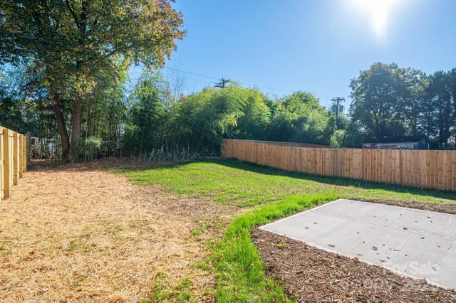 a view of a backyard with a garden and trees
