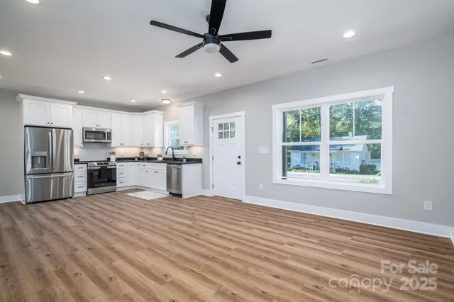 a view of kitchen with stainless steel appliances refrigerator oven microwave and stove