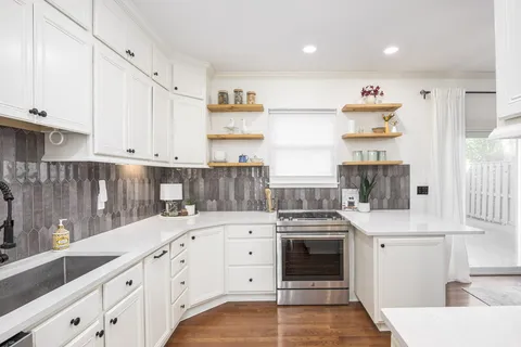 a kitchen with stainless steel appliances a stove a sink and a refrigerator