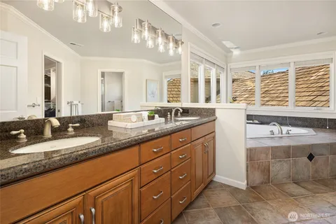 a spacious bathroom with a granite countertop sink and a large mirror