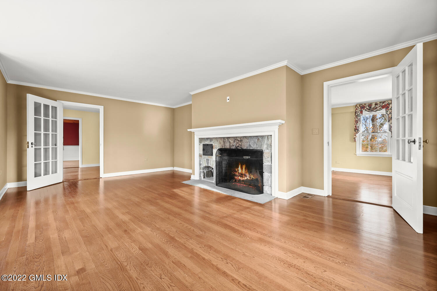 141 Hendrie Avenue Riverside, CT 06878 - Photo 4 of 24 a view of a livingroom with wooden floor and a fireplace