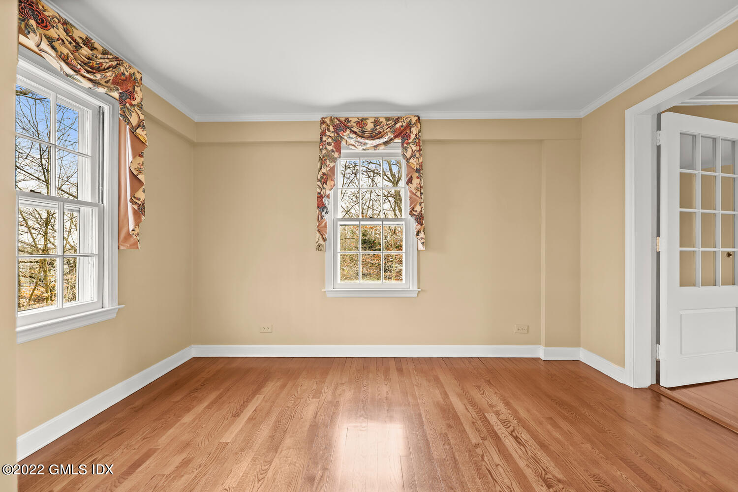 141 Hendrie Avenue Riverside, CT 06878 - Photo 5 of 24 a view of an empty room with wooden floor and a window