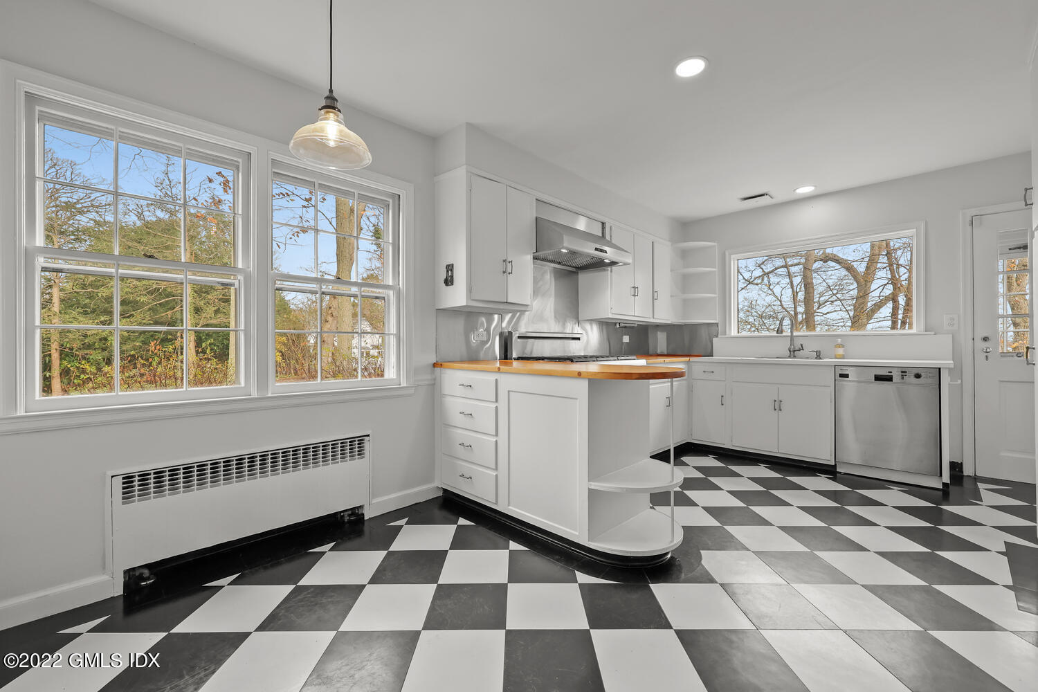 141 Hendrie Avenue Riverside, CT 06878 - Photo 6 of 24 a kitchen with a checkered floor and white cabinets