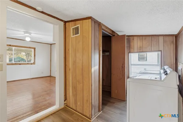 a view of a hallway with closet and wooden floor