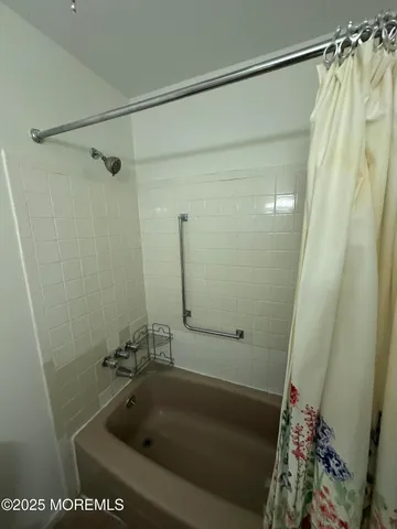 a bath tub sitting next to a shower
