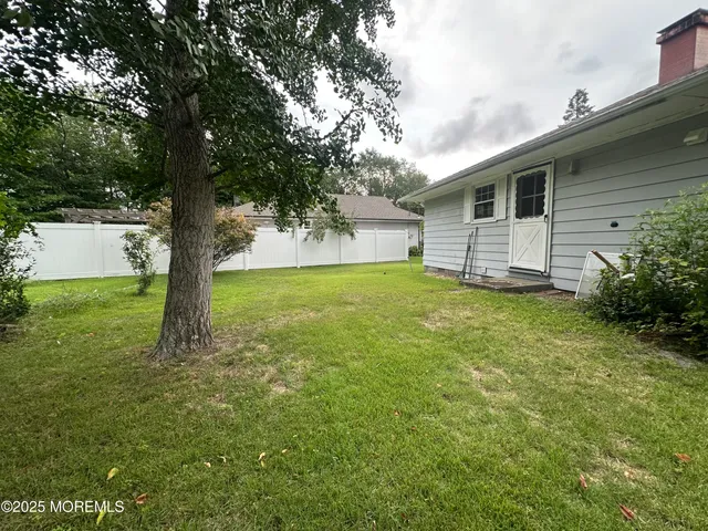 a view of a backyard with large trees