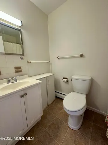 a bathroom with a toilet sink and mirror