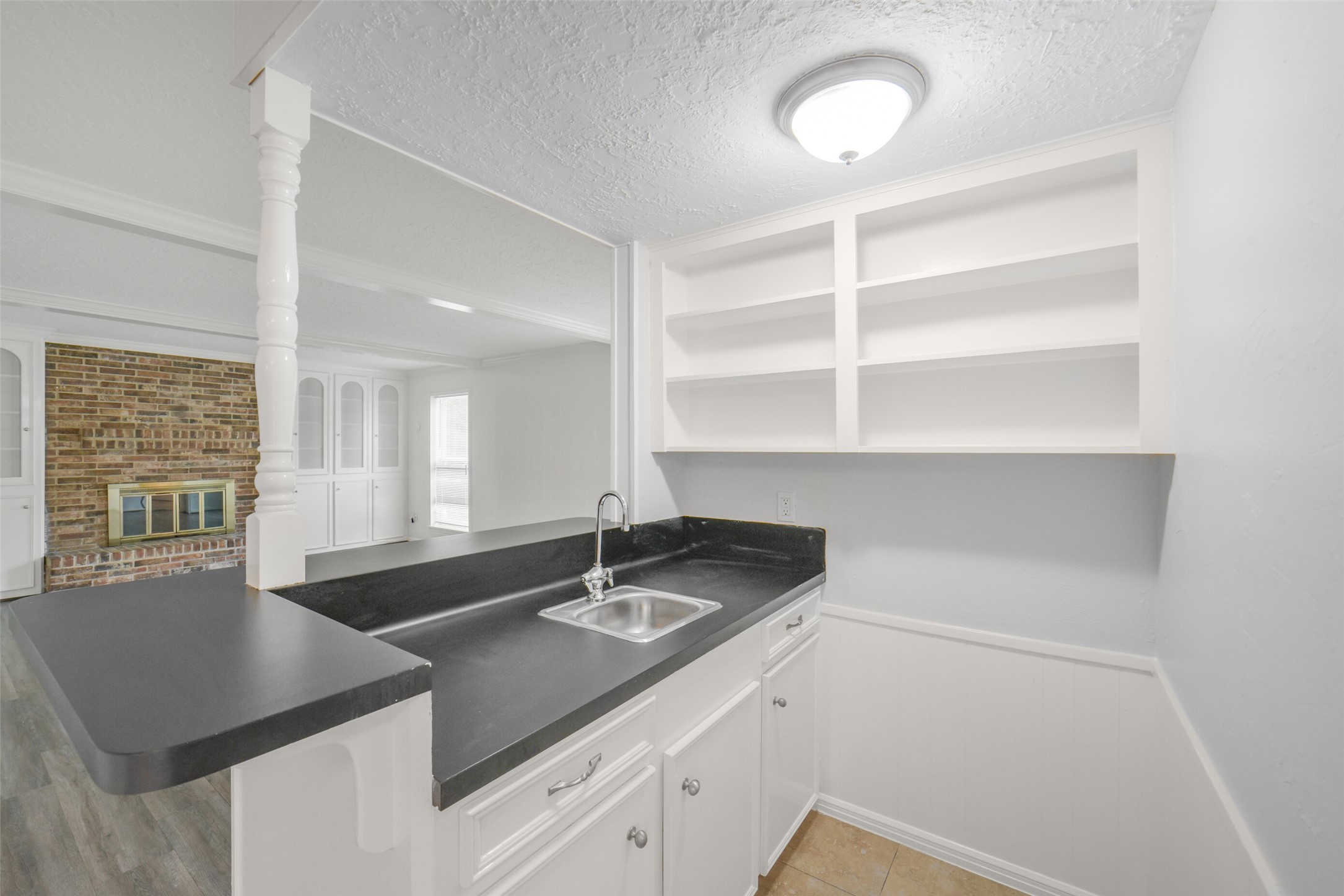 7611 Theisswood Road Spring, TX 77379 - Photo 9 of 41 Wet bar with wood cabinetry, built-in storage, and open shelving.