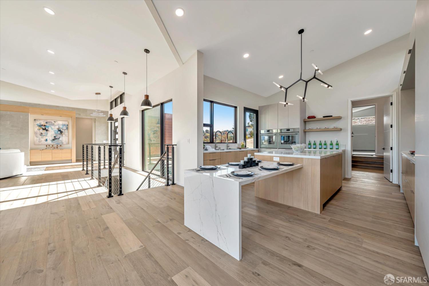 2011 Bishop Road Belmont, CA 94002 - Photo 6 of 35 a large kitchen with stainless steel appliances a large counter top a stove a refrigerator and a view of living room
