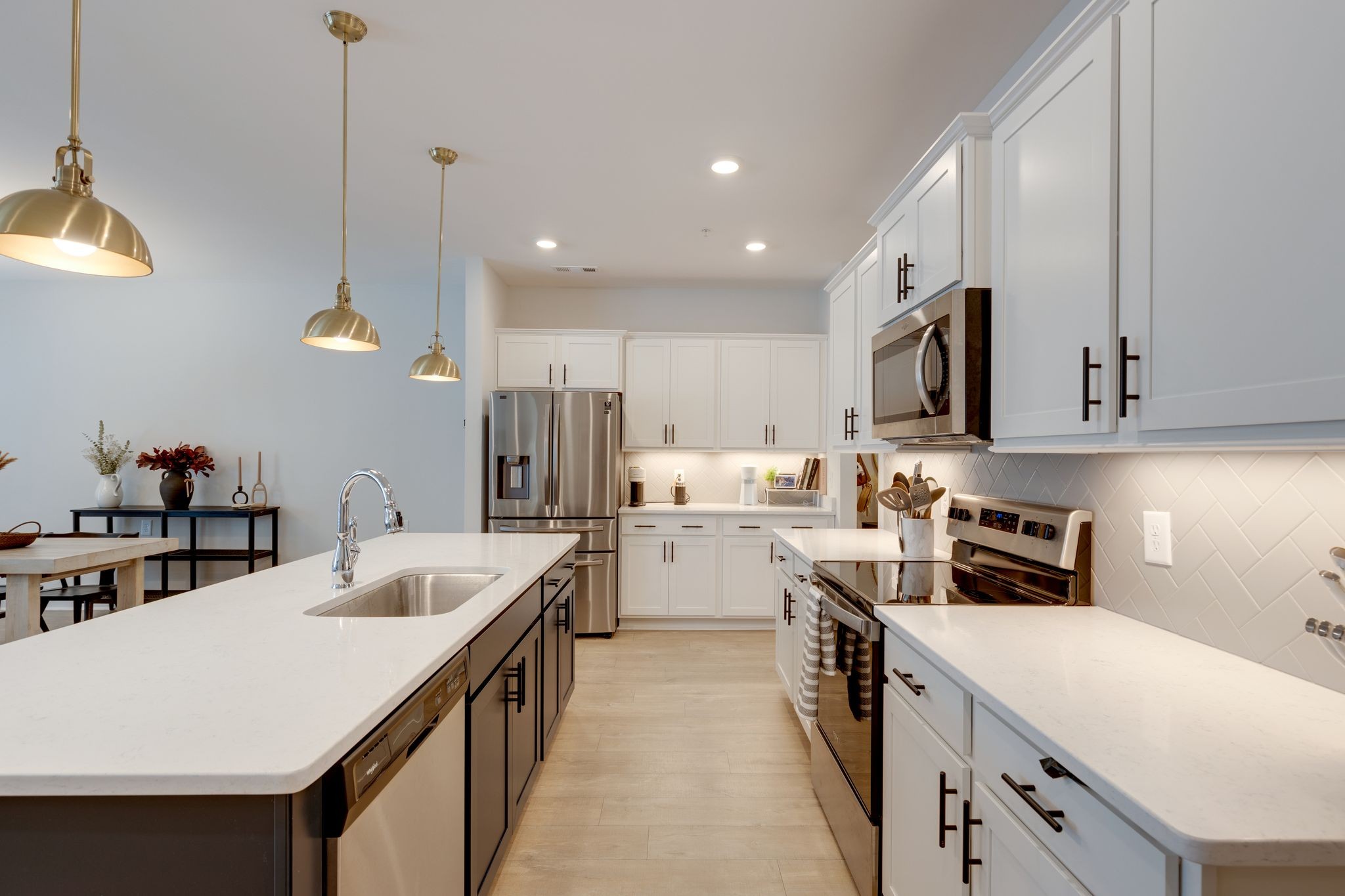 1021 June Wilde Ridge Spring Hill, TN 37174 - Photo 5 of 23 a kitchen with a sink counter top space stainless steel appliances and cabinets