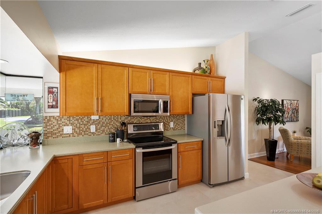 4620 Southeast Quail Trail Stuart, FL 34997 - Photo 19 of 71 a kitchen with stainless steel appliances a refrigerator stove and sink