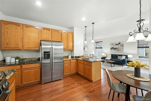 a kitchen with stainless steel appliances granite countertop sink stove top oven and refrigerator