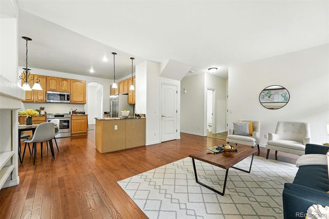 a living room with furniture and kitchen view