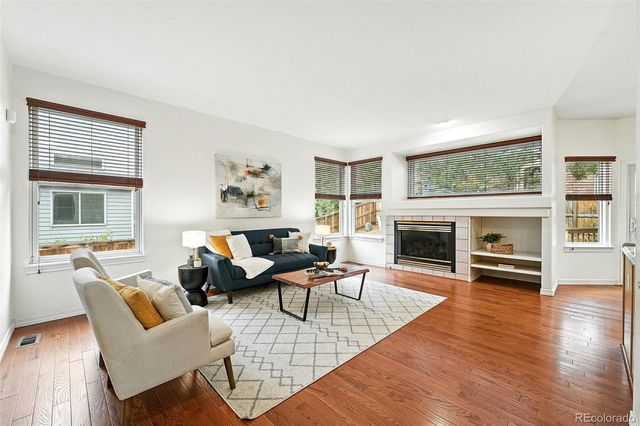 a living room with fireplace furniture and a fireplace