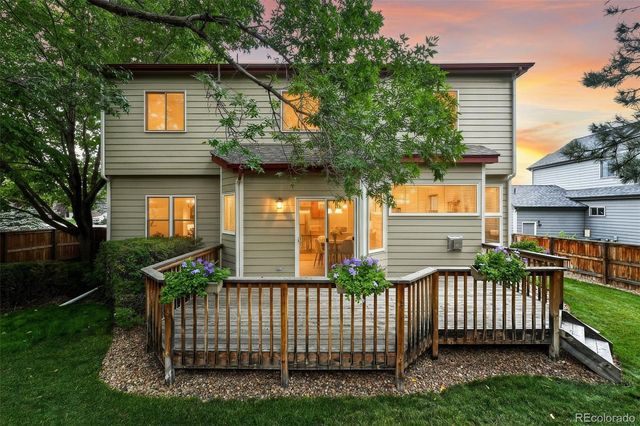 a view of a house with a small yard and a garden
