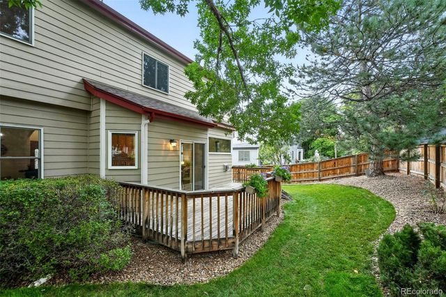 a view of a house with a yard and deck