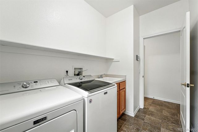 a view of storage and utility room with washer and dryer