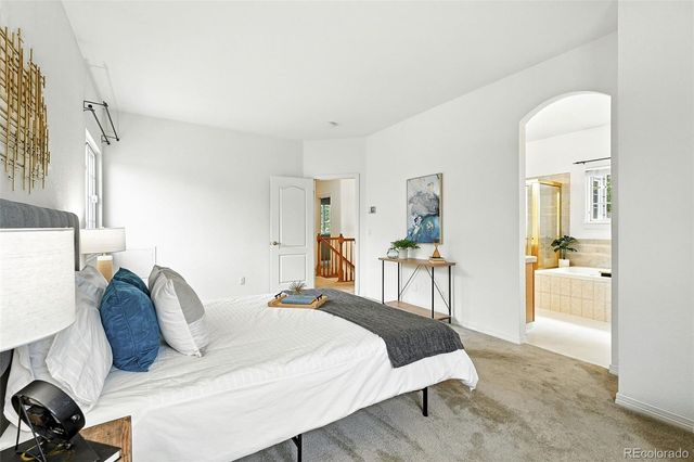 a bed room with a bed and a chair