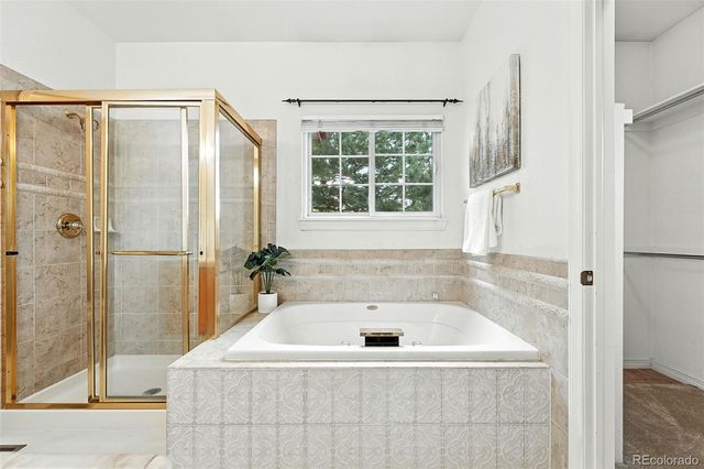 a bathroom with a tub and shower