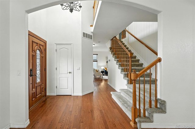 a view of entryway and hall with wooden floor