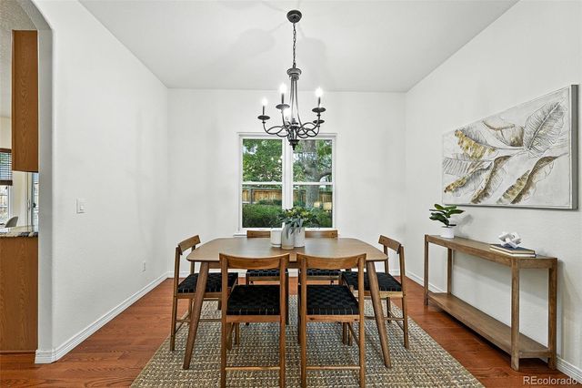 a dining room with furniture a rug and wooden floor