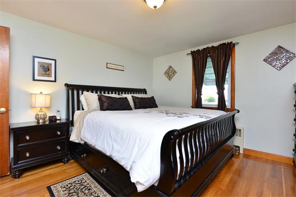 49 Farnham Road Stoughton, MA 02072 - Photo 12 of 28 a bedroom with a bed and wooden floor