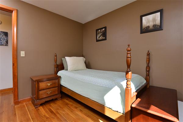 49 Farnham Road Stoughton, MA 02072 - Photo 15 of 28 a bedroom with a bed and wooden floor