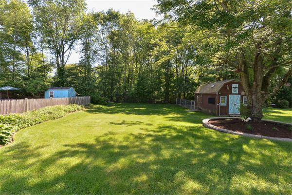 49 Farnham Road Stoughton, MA 02072 - Photo 25 of 28 a backyard of a house with table and chairs