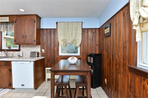 49 Farnham Road Stoughton, MA 02072 - Photo 8 of 28 a kitchen with stainless steel appliances a table chairs and a refrigerator