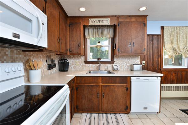 49 Farnham Road Stoughton, MA 02072 - Photo 10 of 28 a kitchen with a sink stove and cabinets