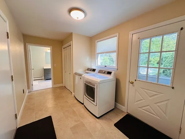 a kitchen with stainless steel appliances white cabinets and wooden floors