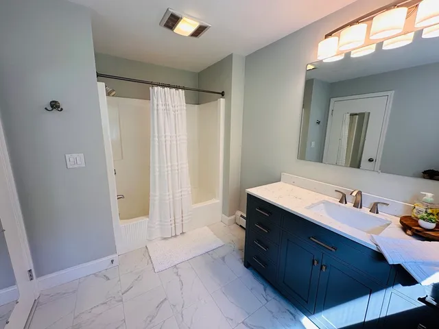 a spacious bathroom with a double vanity sink and a mirror