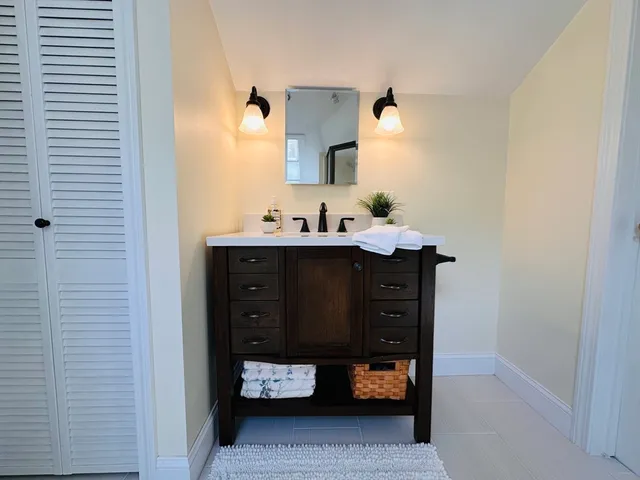 a bathroom with a sink and a mirror