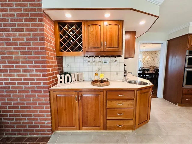 a view of a kitchen with stainless steel appliances granite countertop a sink and a stove