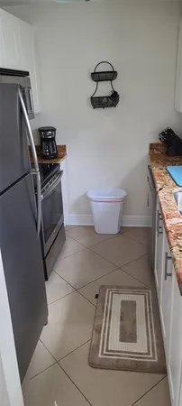 a kitchen with a stove and a refrigerator