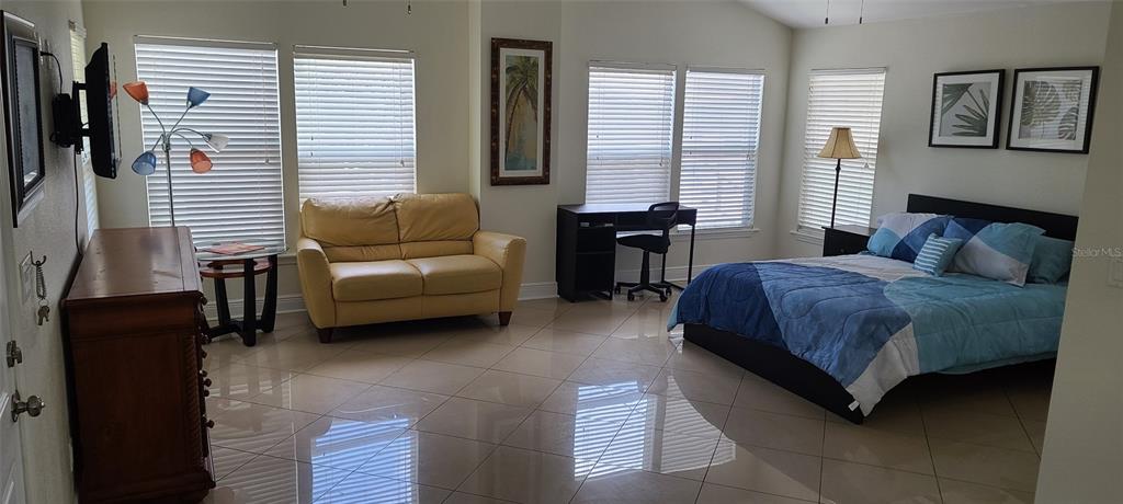 807 Turner Street, Unit 5 Clearwater, FL 33756 - Photo 6 of 6 a bedroom with a bed and a couch next to a window