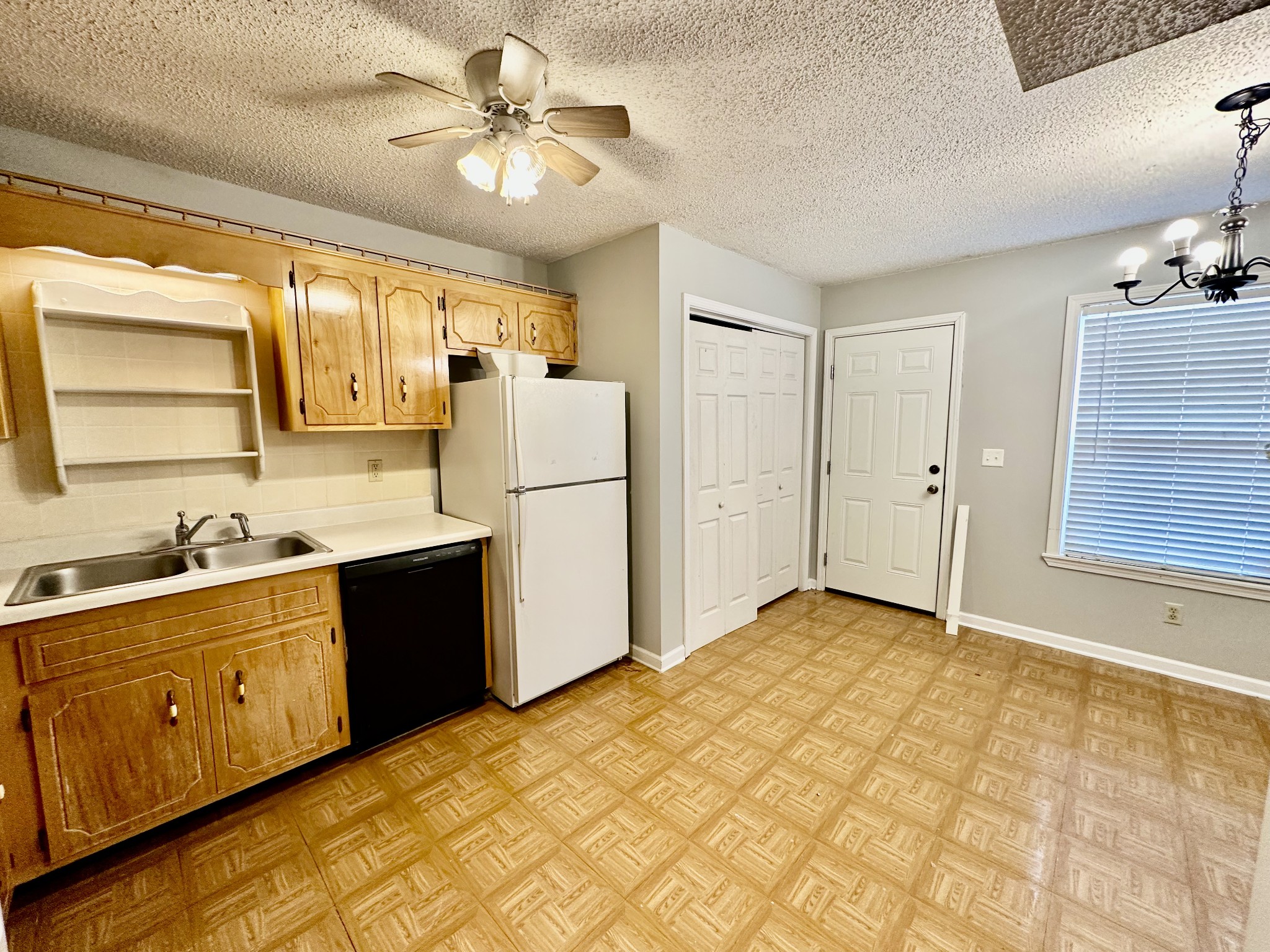 282 Raleigh Drive, Unit B Clarksville, TN 37043 - Photo 6 of 15 a kitchen with a refrigerator a sink cabinets and wooden floor