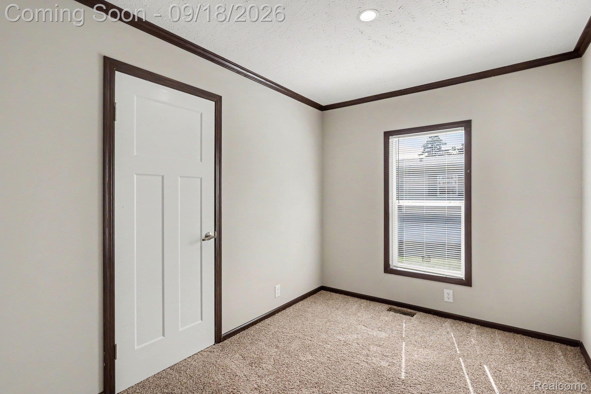 470 Flamingo Street Rochester, MI 48309 - Photo 8 of 17 Recessed ceiling lighting, window with blinds, carpeted flooring, white paneled door, and dark wood-finish trim