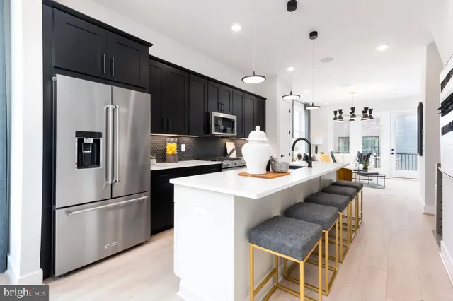 a kitchen with stainless steel appliances a refrigerator stove microwave and cabinets