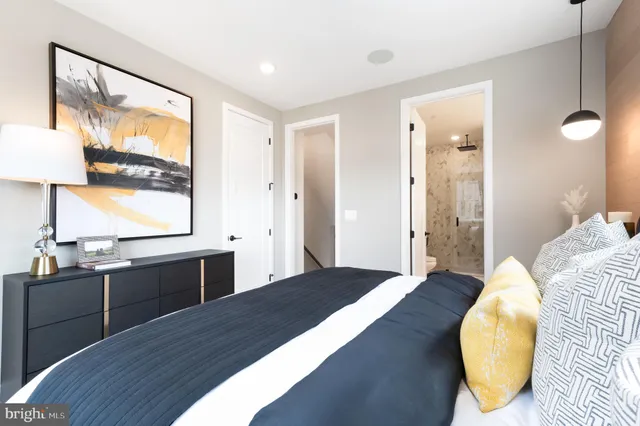 a spacious bedroom with a bed and a large window