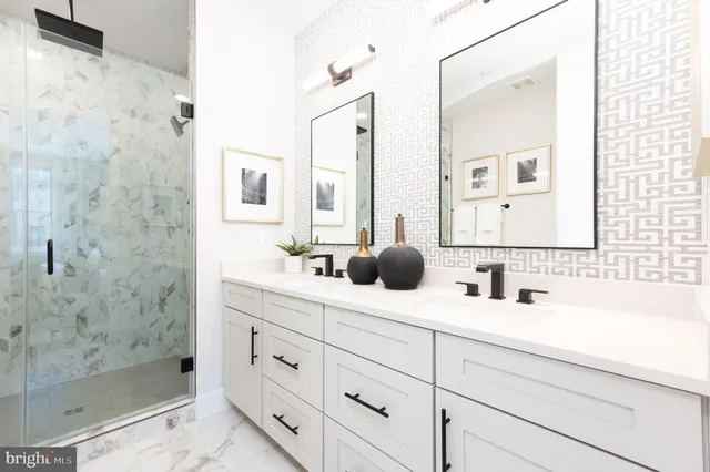 a bathroom with double sink and a mirror