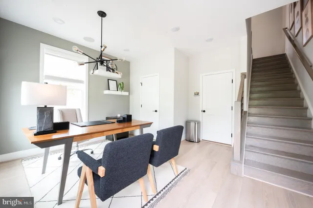 a view of a workspace with furniture and a window